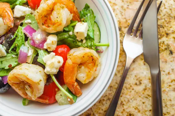 Fresh Greek salad with grilled shrimp and feta cheese with balsamic vinaigrette dressing