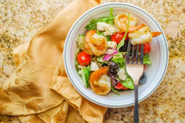 Fresh Greek salad with grilled shrimp and feta cheese with balsamic vinaigrette dressing