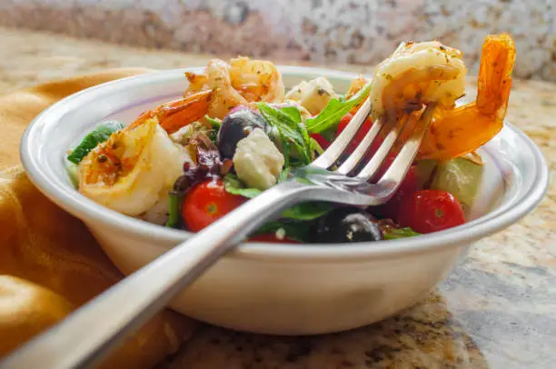 Fresh Greek salad with grilled shrimp and feta cheese with balsamic vinaigrette dressing