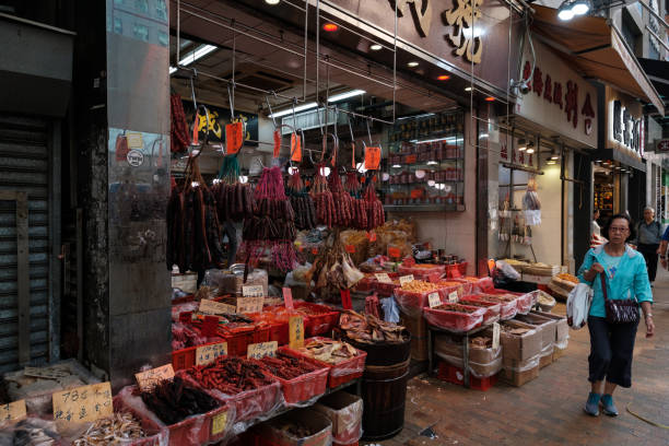 Butcher selling meat on street market store in Hong Kong HongKong, China - November, 2019: Butcher selling meat on street market store in Hong Kong pig farmer china stock pictures, royalty-free photos & images