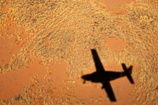 Shadow of small plane, aerial view Damaraland, Kaokoland wilderness in NW region of Namibia, Africa