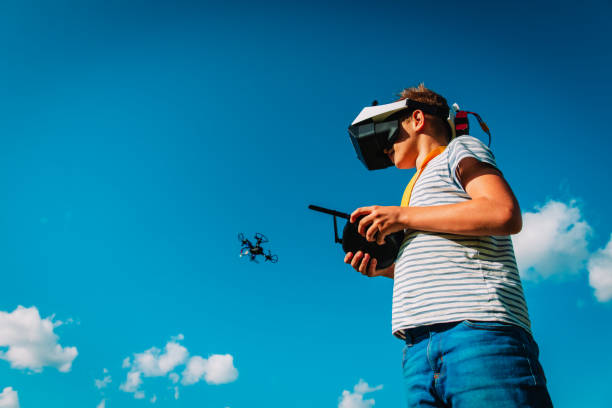 istock boy flying drone in virtual reality glasses in nature 1265669643