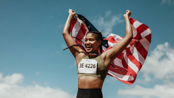 istock Runner celebrating victory outdoors holding the US flag 1265670671