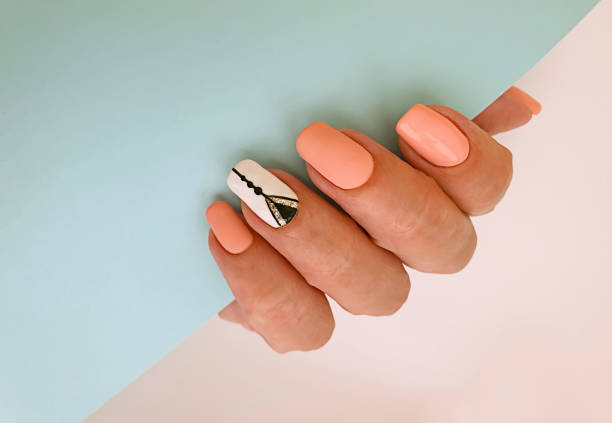 istock female hand beautiful manicure on a colored background 1265671785