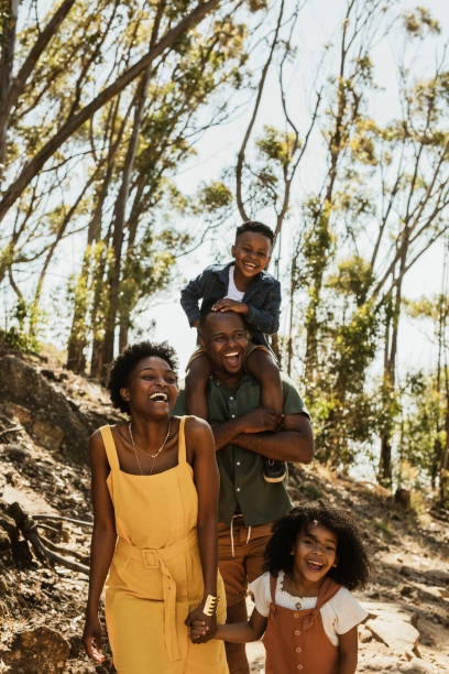 istock Family walking down mountain trail and smiling 1265672113