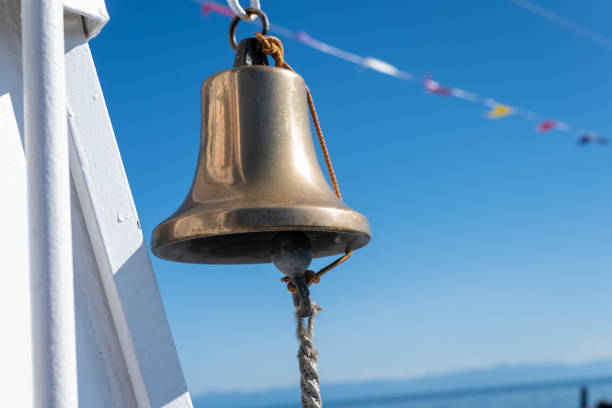 istock Ship's bell against the blue sky, close up. 1265672232