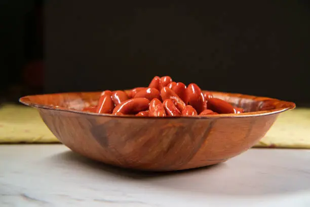 Chili ingredients wooden bowl kidney beans on marble counter