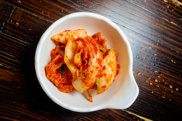 Bowl Spicy Korean Kimchi Bowl spicy korean kimchi with gochugaru chili pepper banchan stock pictures, royalty-free photos & images