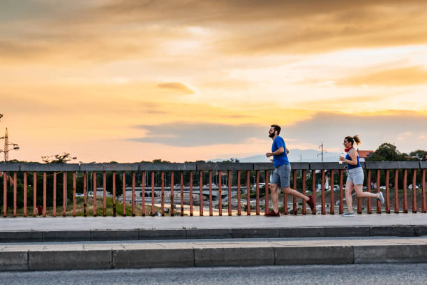 istock Young couple running together 1265675093