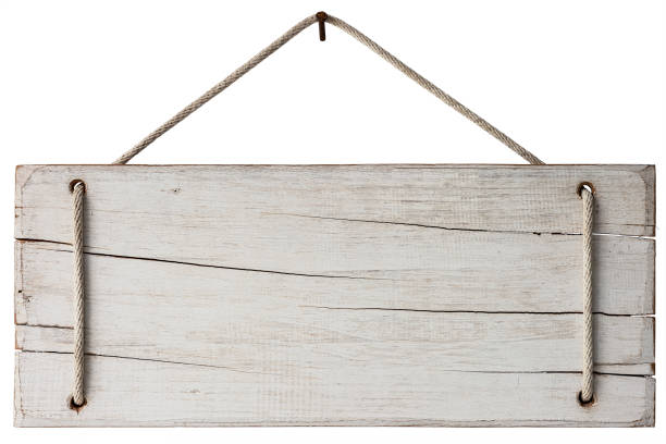 istock Old weathered white wood sign/signboard panel hanging by an old rope from a rusty nail against an isolated white background. Clipping path included. 1265675691