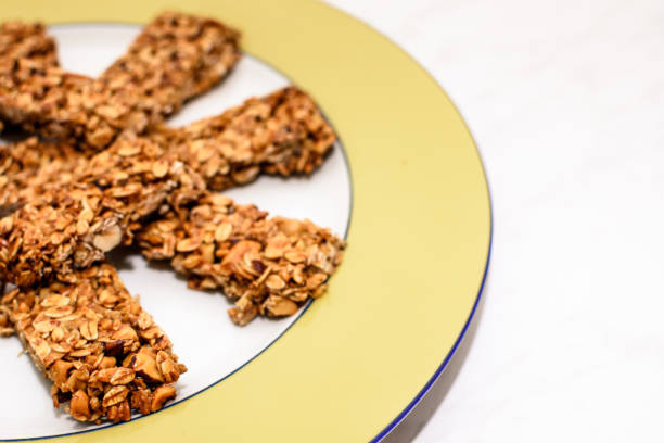 istock Homemade oat and peanut protein bars on a yellow serving plate 1265677290