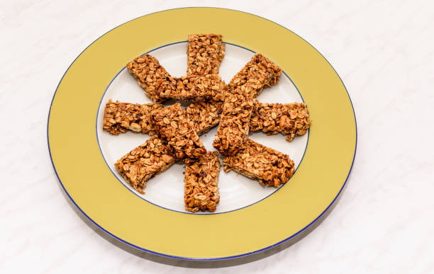 istock Homemade oat and peanut protein bars on a yellow serving plate 1265677294