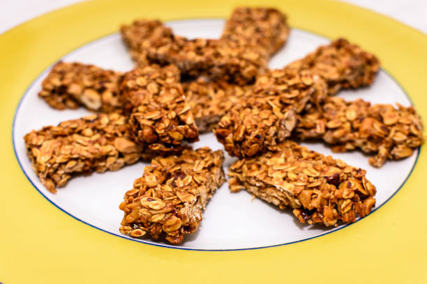 Homemade oat and peanut protein bars on a yellow serving plate