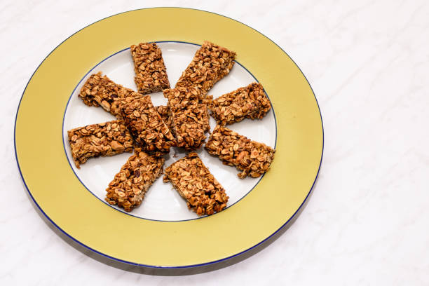 istock Homemade oat and peanut protein bars on a yellow serving plate 1265677300