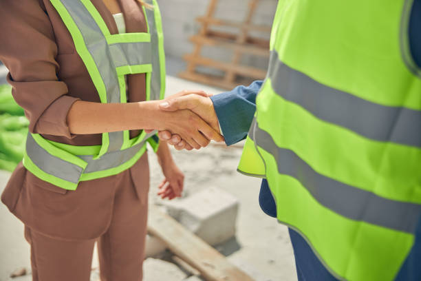 istock Modern woman and her colleague shaking hands 1265679243