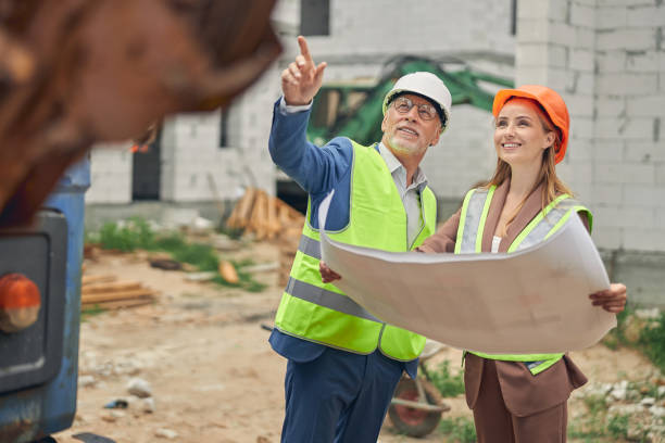 istock Male worker pointing at something to a female contractor 1265679336