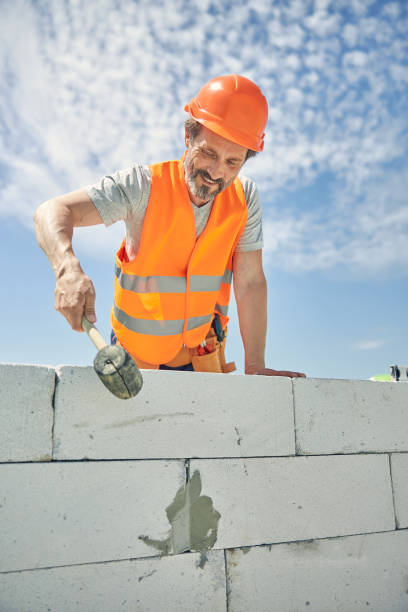 istock Smiling mason with a construction tool outdoors 1265679365