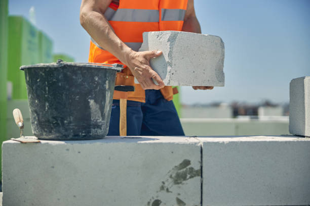 istock Strong male hands holding a white brick 1265679376