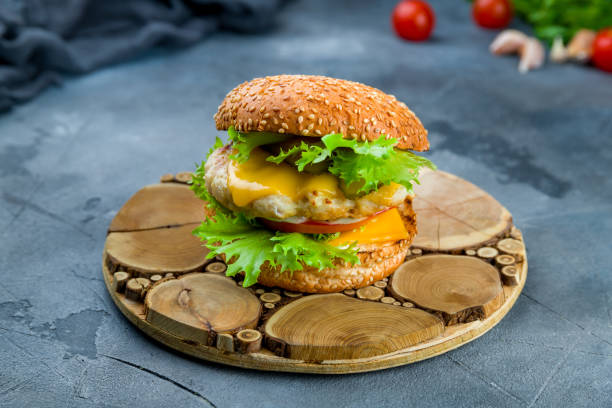 burger with chicken on grey table - turkey burger imagens e fotografias de stock