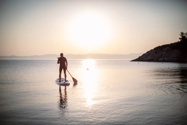 istock Senior man ridding paddle board 1265682686