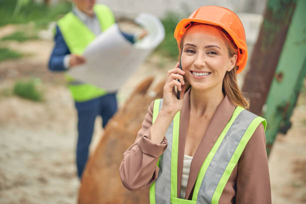 istock Cheerful lady calling on her cellular phone 1265683565