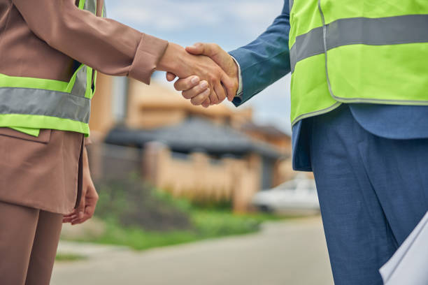 istock Woman and a male engineer shaking hands 1265683608