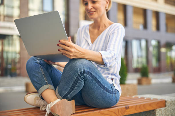 istock Blonde stylish woman working on her gadget 1265684545