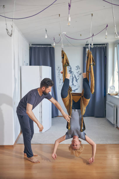 istock Fit calm Caucasian lady practicing flying yoga 1265684575