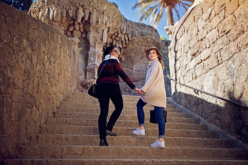 Girlfriends are exploring Park Guell/Barcelona