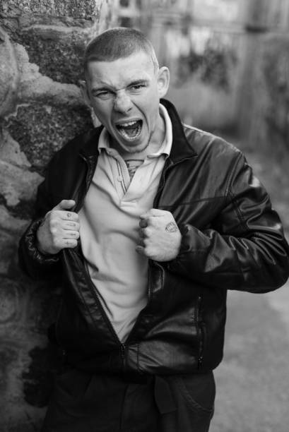 istock Bully criminal in black leather jacket. Black and white photo 1265687978