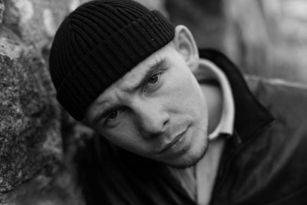 istock Bully criminal in black leather jacket. Black and white photo 1265688007