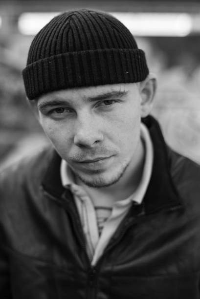 istock Bully criminal in black leather jacket. Black and white photo 1265688031
