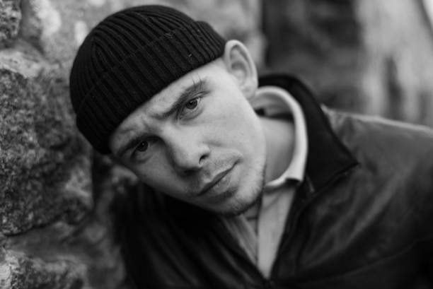 istock Bully criminal in black leather jacket. Black and white photo 1265688396