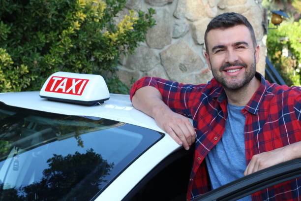 Taxi driver smiling at work Taxi driver smiling at work. taxi driver stock pictures, royalty-free photos & images