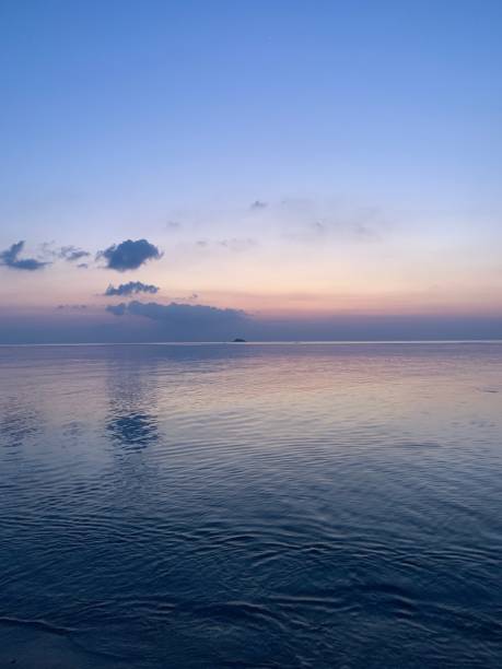 istock Calm beach waters underbeath lavendar sunset 1265690540