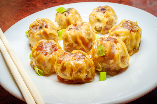 Delicious Chinese Dim Sum dumplings topped with scallions
