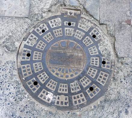 Manhole cover in a dutch street, selective focus