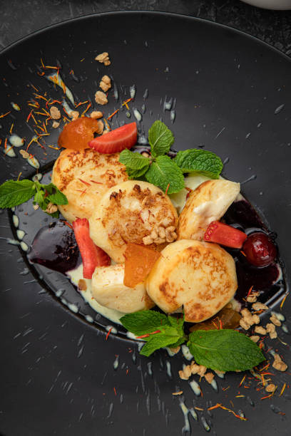 istock Ukrainian cheesecakes with sauces, berries and mint i 1265696550