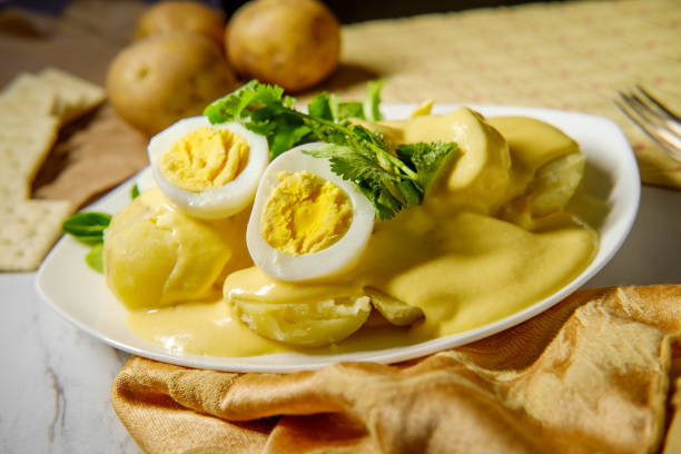 Pope to La Huancaina Papa a la Huancaina Peruvian potatoes and hard boiled eggs with spicy aji amarillo yellow sauce fresh cilantro stock pictures, royalty-free photos & images