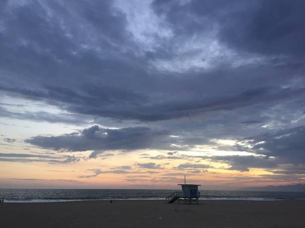 istock Landscape view of lifeguard tower on empty sand beach at sunset 1265698257