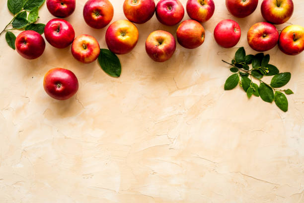 istock Ripe red apples with leaves - top view, copy space 1265700777