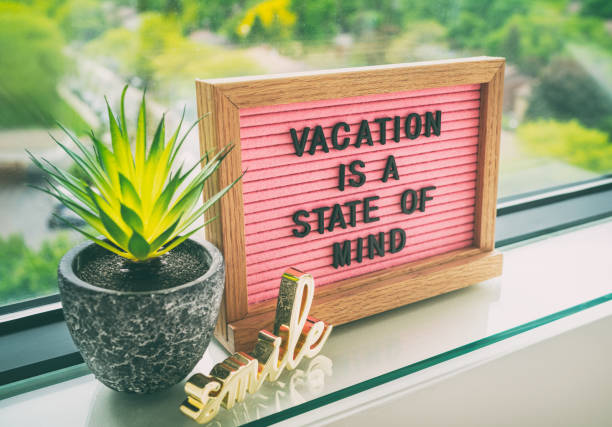 istock Vacation is a state of mind positive inspirational quote text on message board for summer holiday travel during COVID-19 coronavirus. Staycation pink felt board text for staying home 1265702310