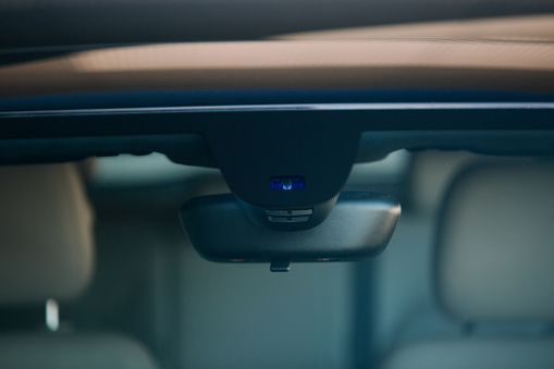 Rain and light sensor on the windshield of the car