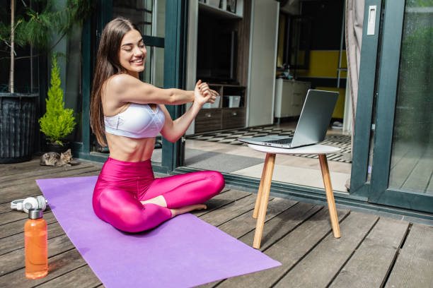 istock Woman practicing at home with laptop 1265702491