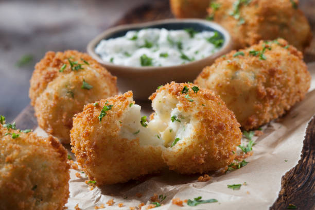 Creamy Mashed Potato Croquettes with Cheese and Sour Cream Dip Creamy Mashed Potato Croquettes with Cheese and Sour Cream Dip fritter photos stock pictures, royalty-free photos & images