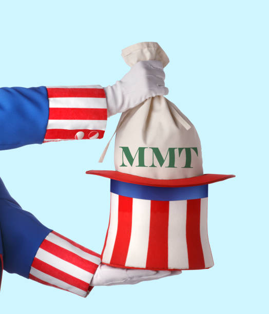 Uncle Sam Pulling Money Out Of His Hat Uncle Sam pulls a money bag out of his hat that is labeled MMT. MMT represents the contemporary modern monetary theory. MMT is a theory that suggests governments are not bound by traditional assumptions of government spending and debt. uncle sam broke stock pictures, royalty-free photos & images