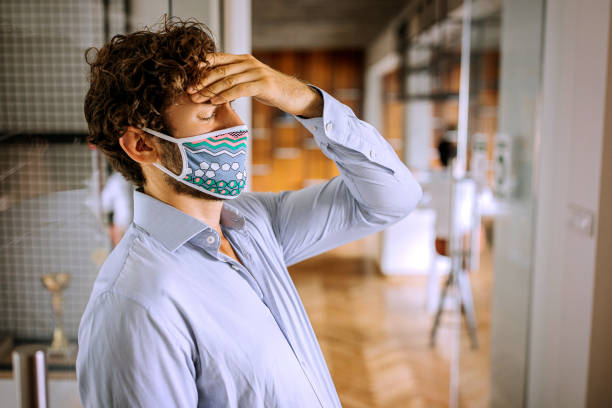 istock Trying to cope with a stress during pandemic at office 1265710962