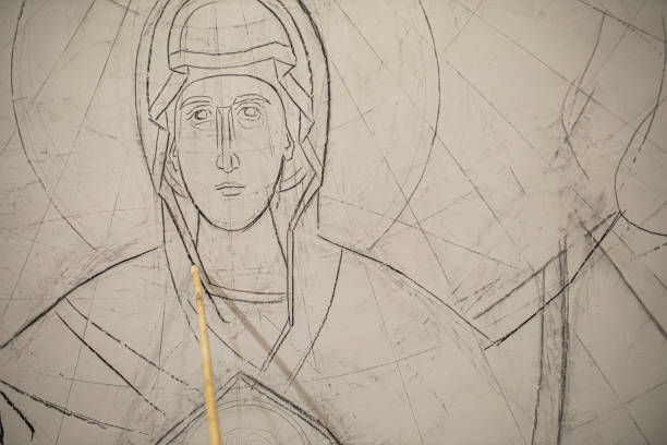 sketching the figure of the virgin mary on the wall of the church - restoring art painting artist imagens e fotografias de stock