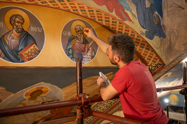 painter finishing details to the orthodox church wall frescoes - restoring art painting artist imagens e fotografias de stock