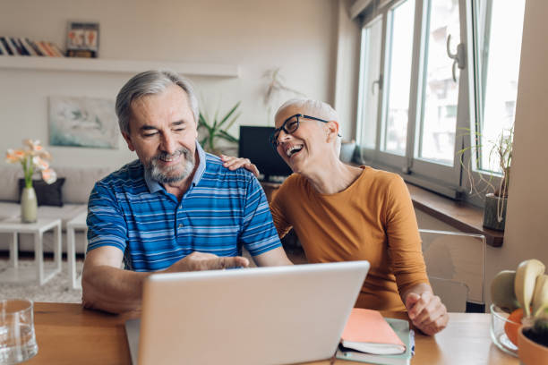 istock Happy senior couple working from their home office 1265724229